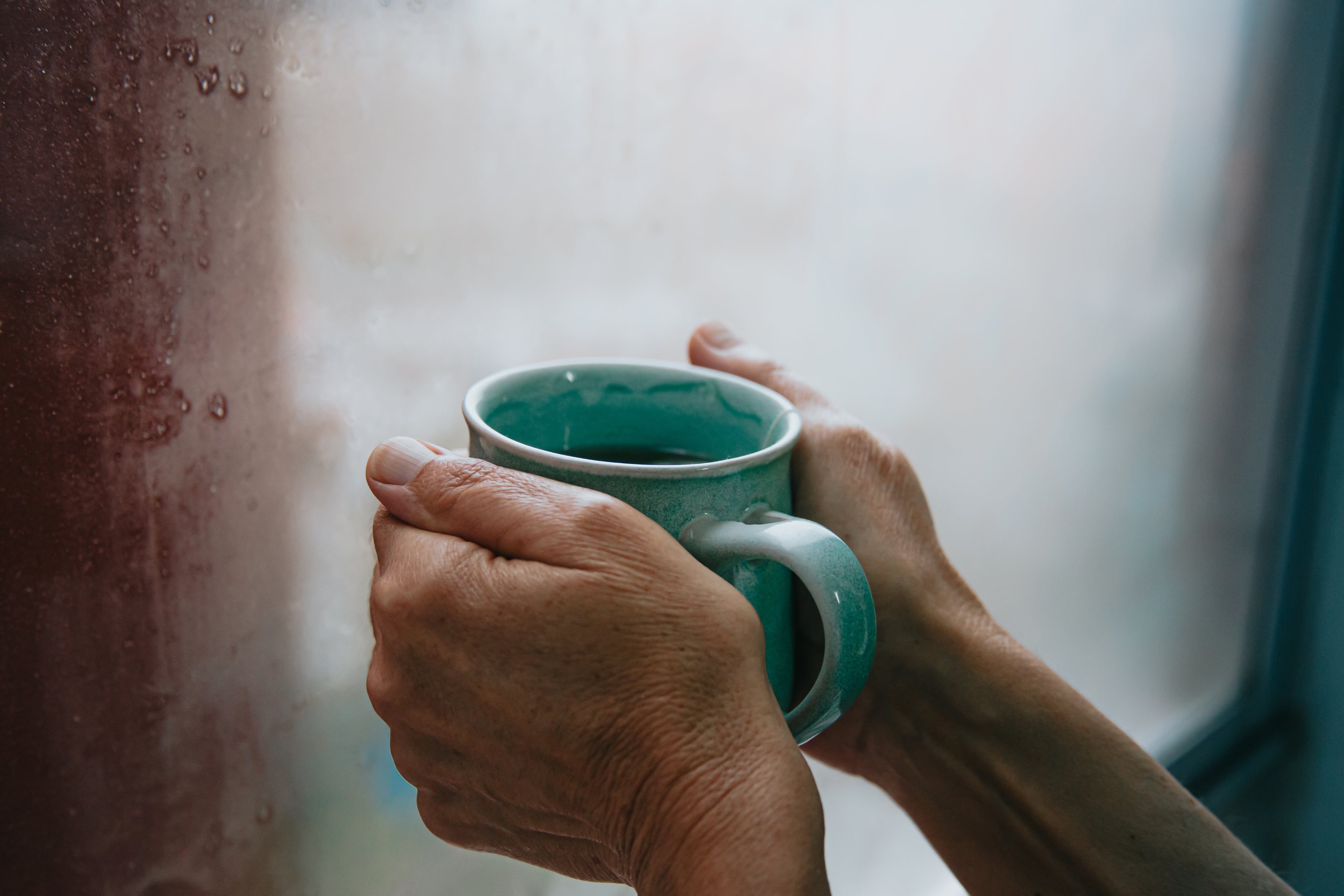 hands-holding-a-green-mug.jpg