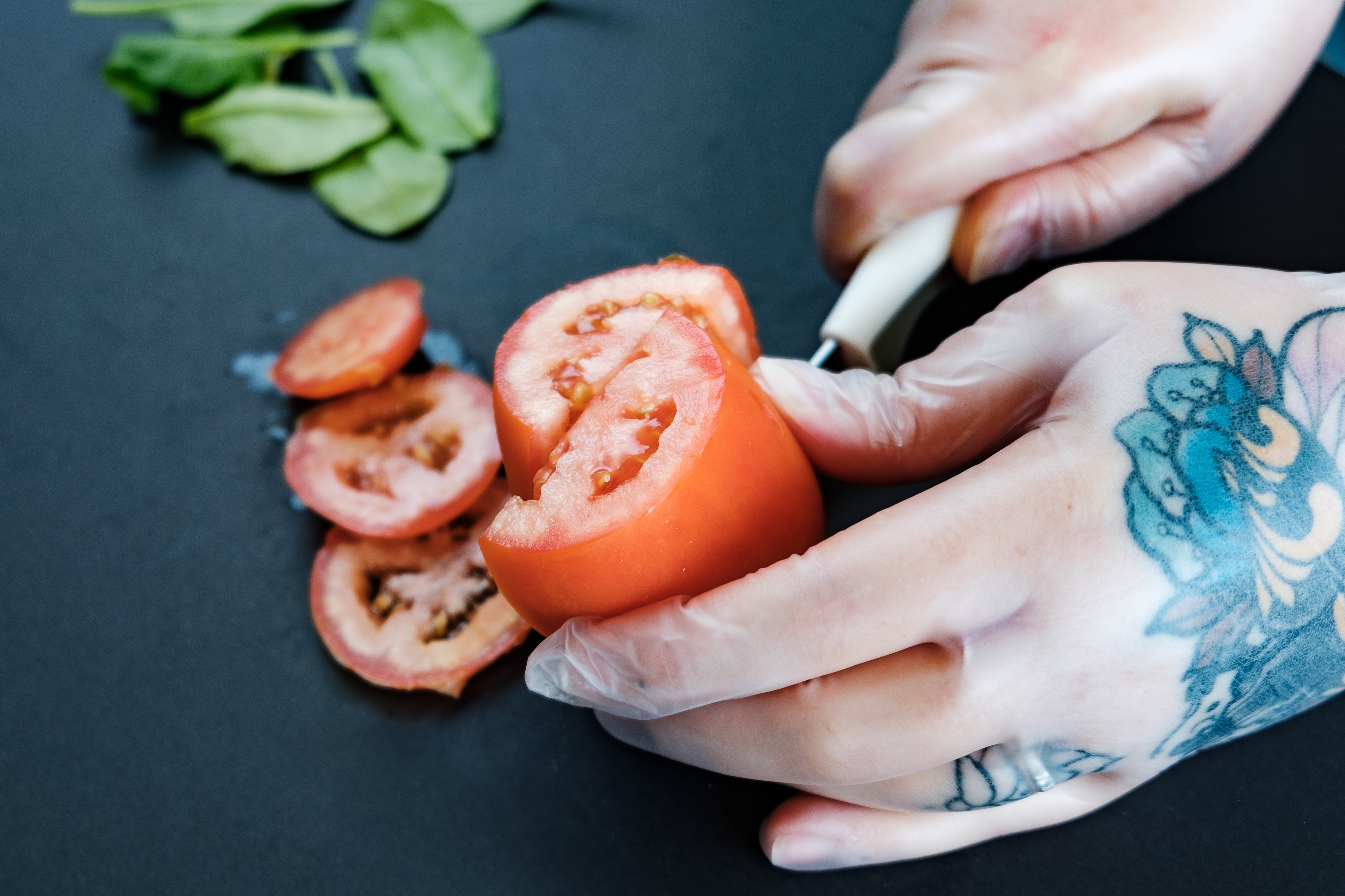 tattooed-hands-preparing-food-with-gloves.jpg